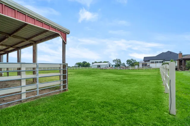 a view of a field with a house in the background