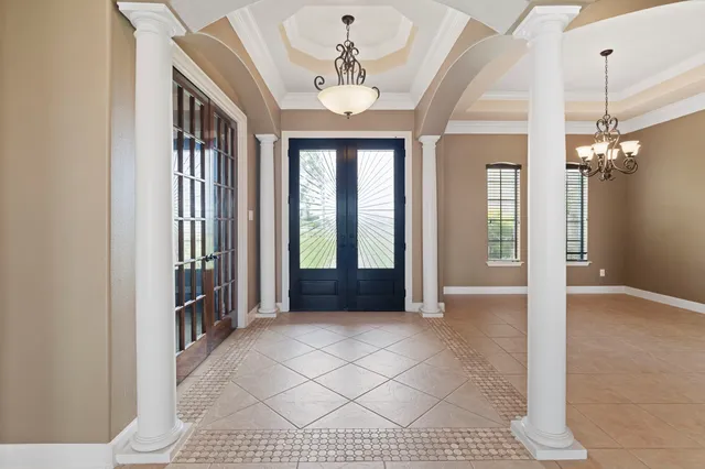 a view of a room with windows and chandelier