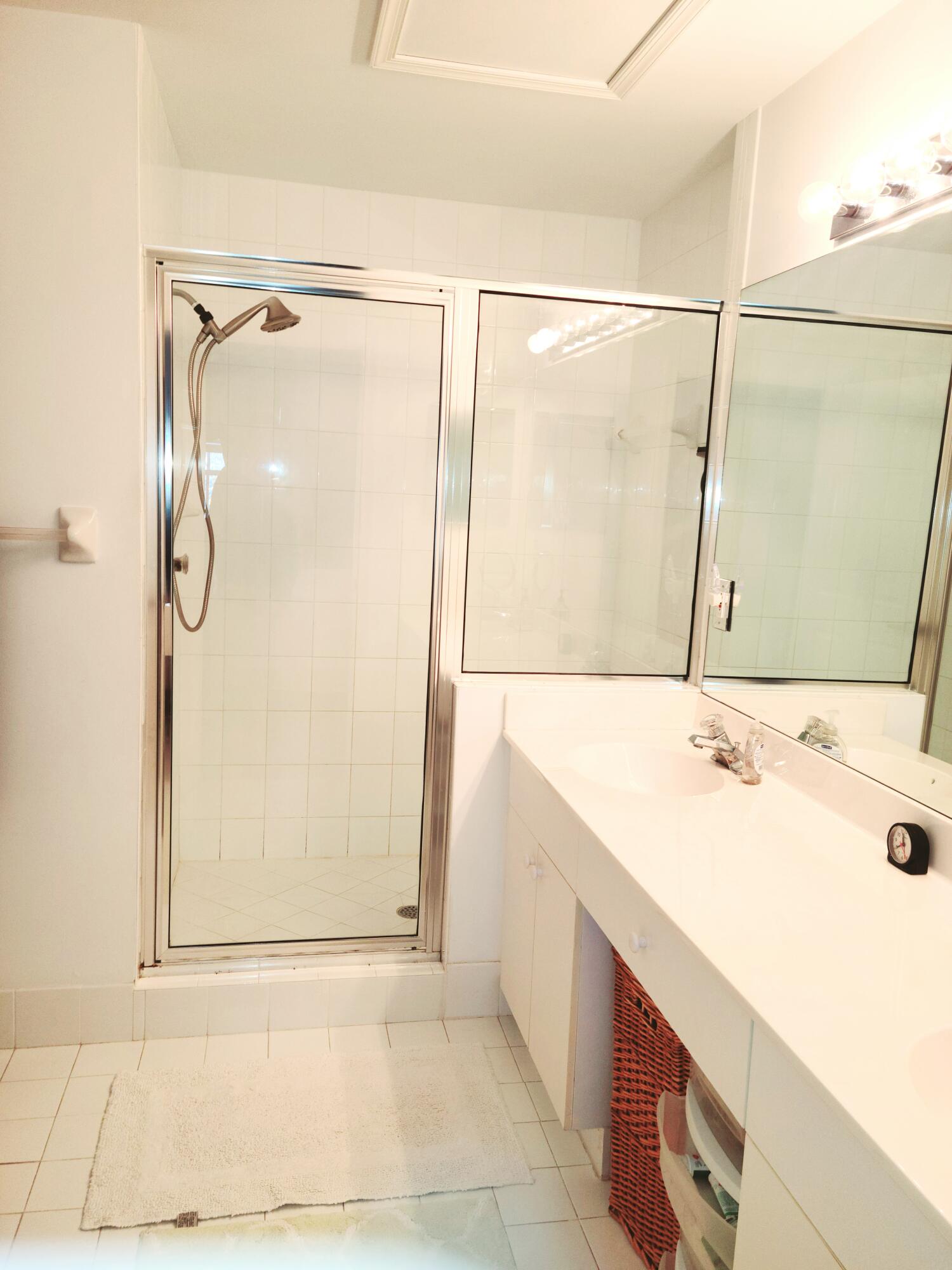 5121 Sabal Gardens Lane, Unit 2 Boca Raton, FL 33487 - Photo 17 of 25 a bathroom with a sink and a mirror
