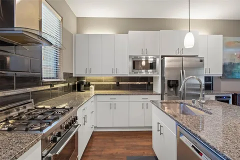 a kitchen with a sink stove and cabinets