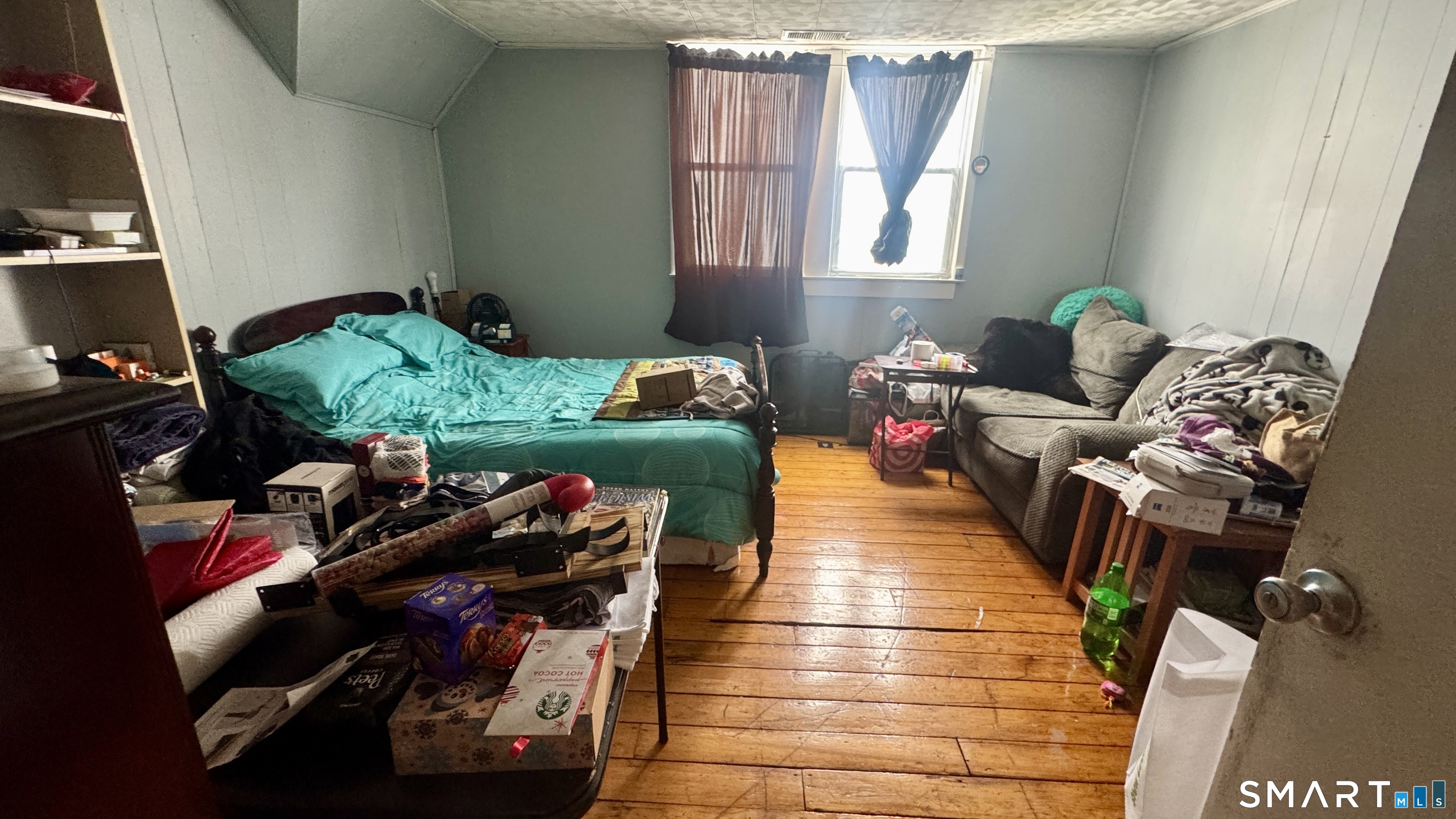 61 Randolph Avenue Meriden, CT 06451 - Photo 20 of 40 a living room with furniture and a book shelf
