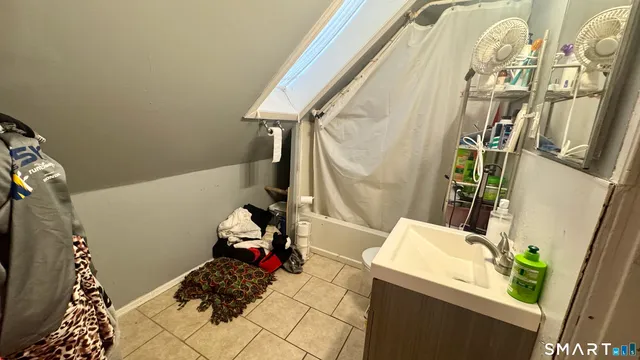 a bathroom with a shower and a curtain