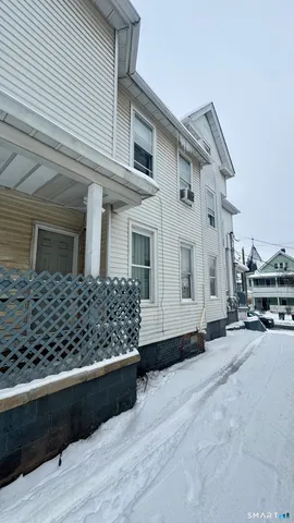 a view of a house with wooden fence