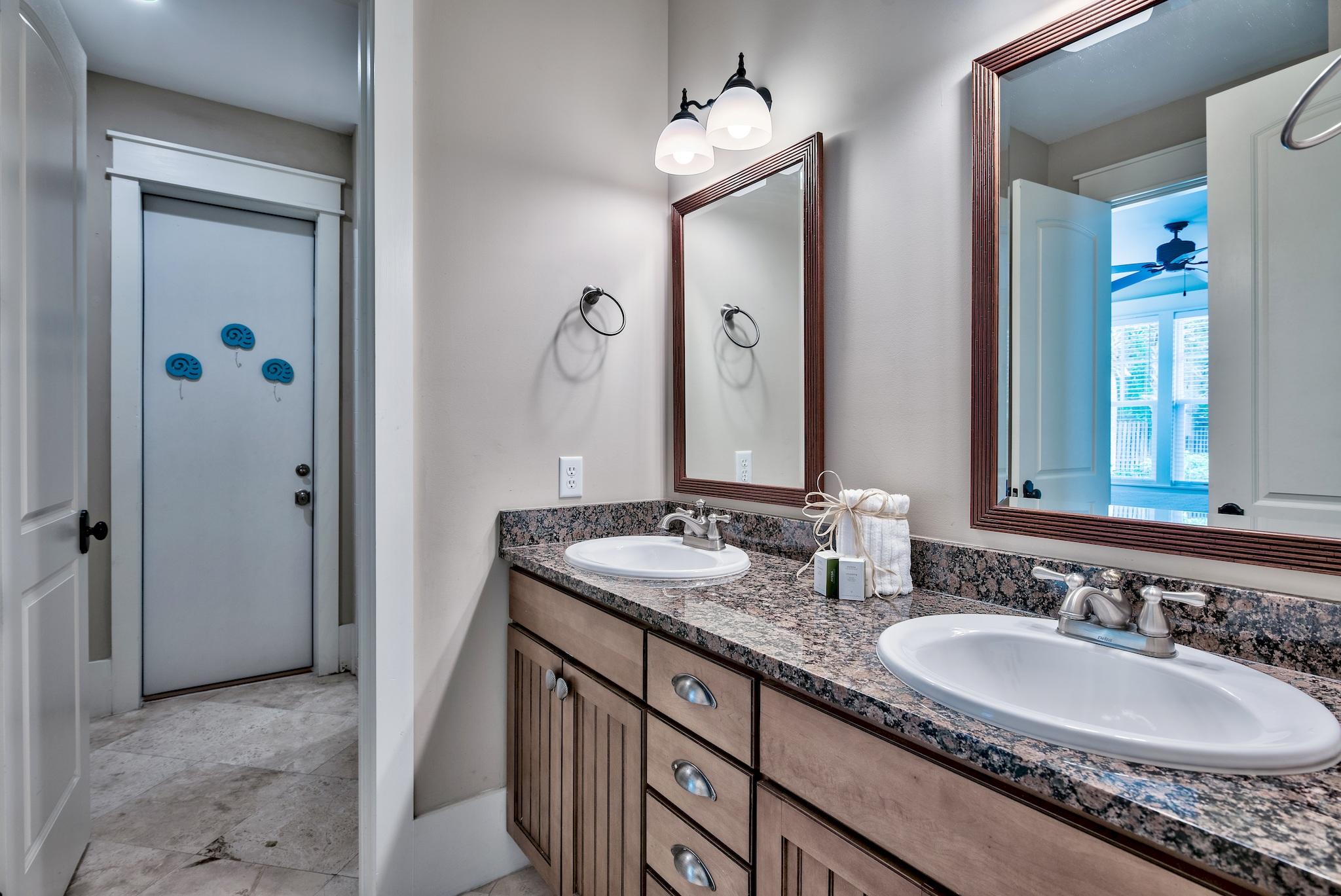 8045 East County Highway 30A Inlet Beach, FL 32461 - Photo 14 of 38 a bathroom with a granite countertop double vanity sink and a mirror