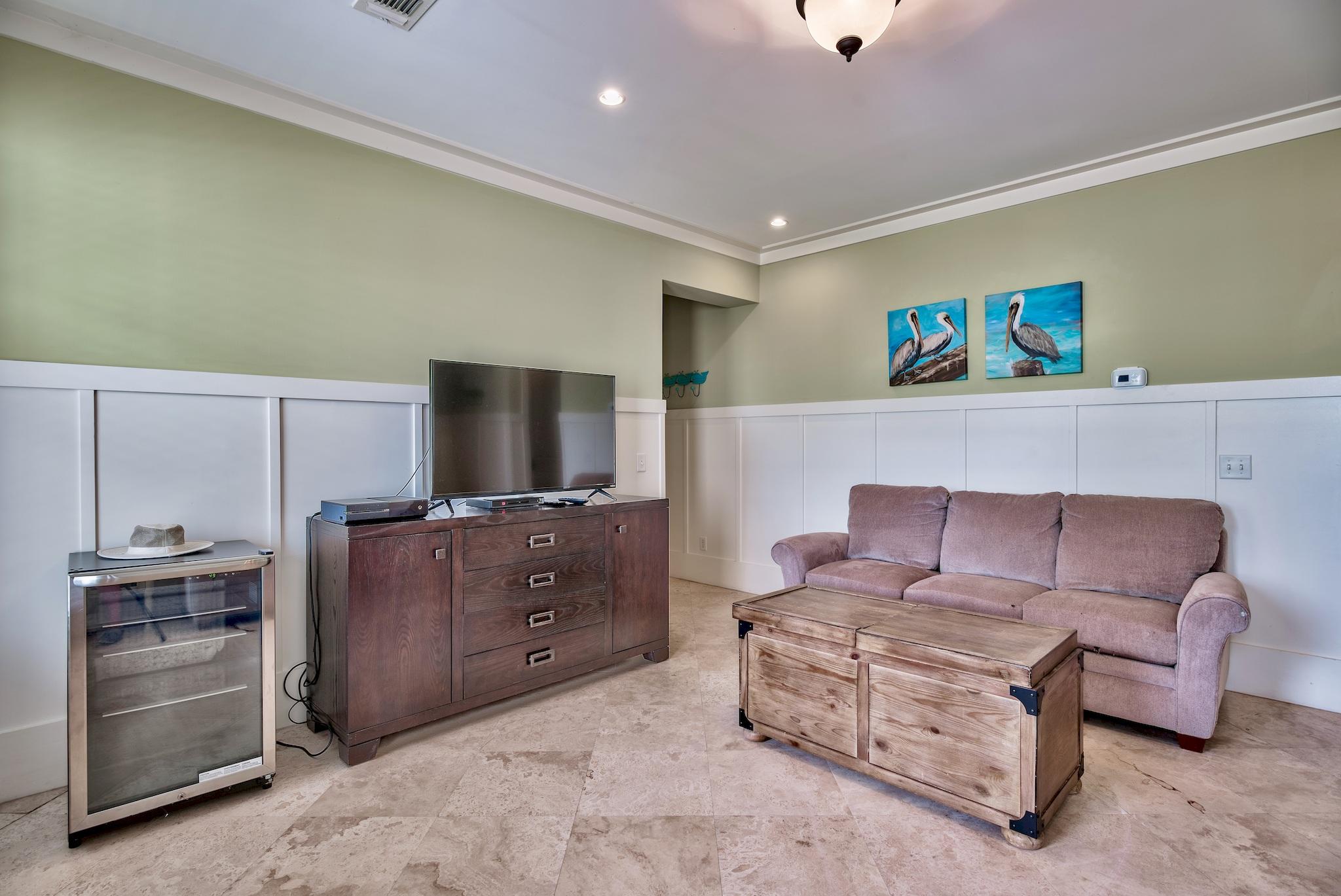 8045 East County Highway 30A Inlet Beach, FL 32461 - Photo 24 of 38 a living room with furniture and a flat screen tv