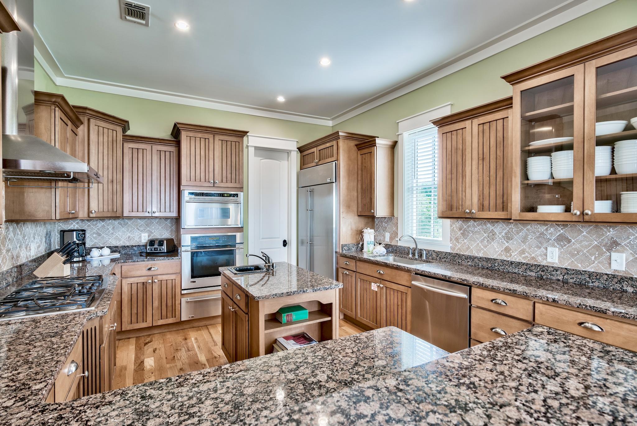 8045 East County Highway 30A Inlet Beach, FL 32461 - Photo 8 of 38 a kitchen with stainless steel appliances granite countertop sink stove and granite counter top