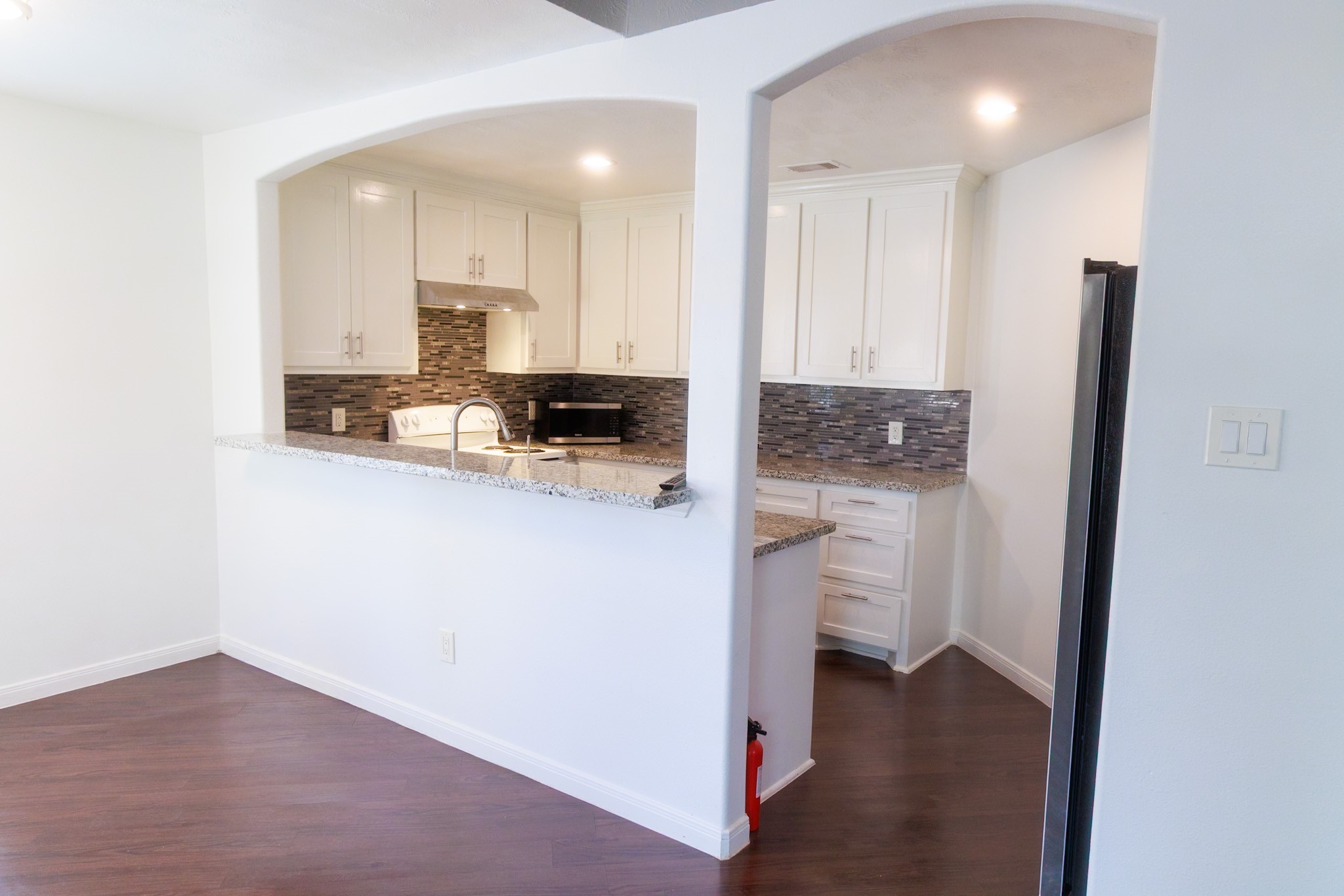 14334 Texarkana Street Houston, TX 77015 - Photo 7 of 26 a kitchen with white cabinets and refrigerator