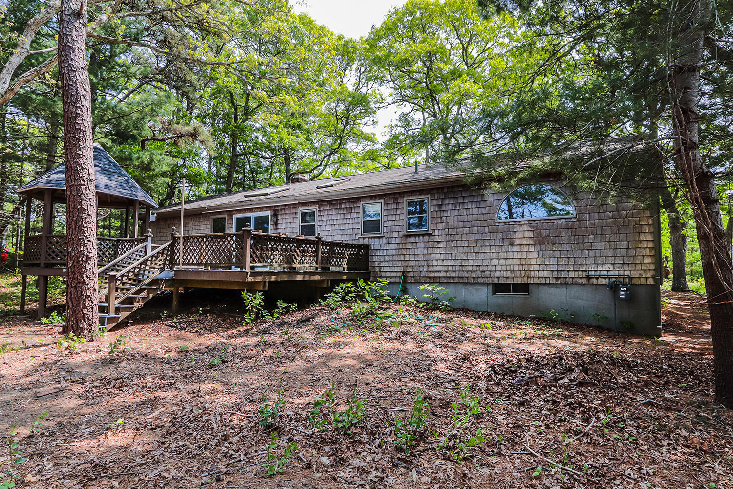882 Bumps River Road Centerville, MA 02632 - Photo 22 of 23 a view of house with backyard outdoor seating and trees