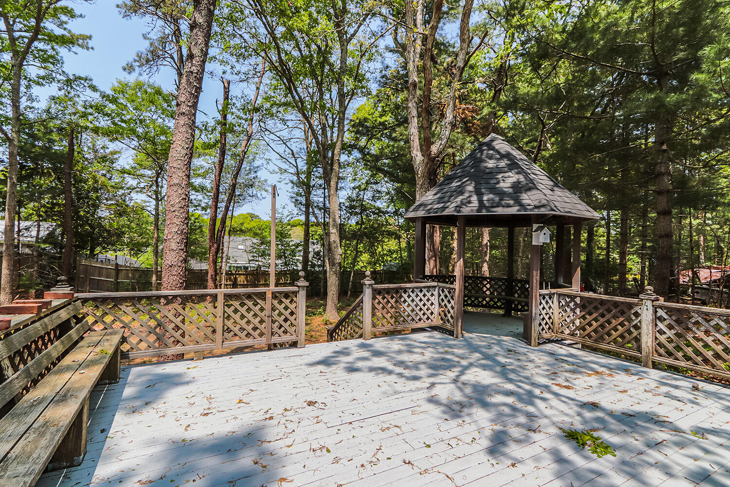 882 Bumps River Road Centerville, MA 02632 - Photo 23 of 23 a wooden bench sitting in front of a house