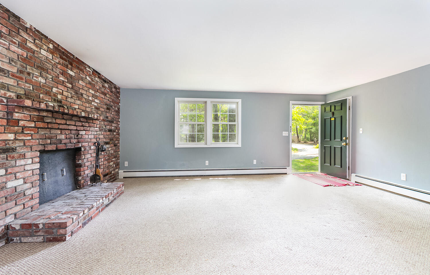 882 Bumps River Road Centerville, MA 02632 - Photo 4 of 23 an empty room with windows and fireplace