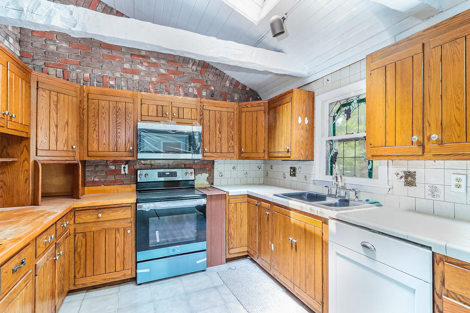 882 Bumps River Road Centerville, MA 02632 - Photo 9 of 23 a kitchen with stainless steel appliances granite countertop a sink and cabinets