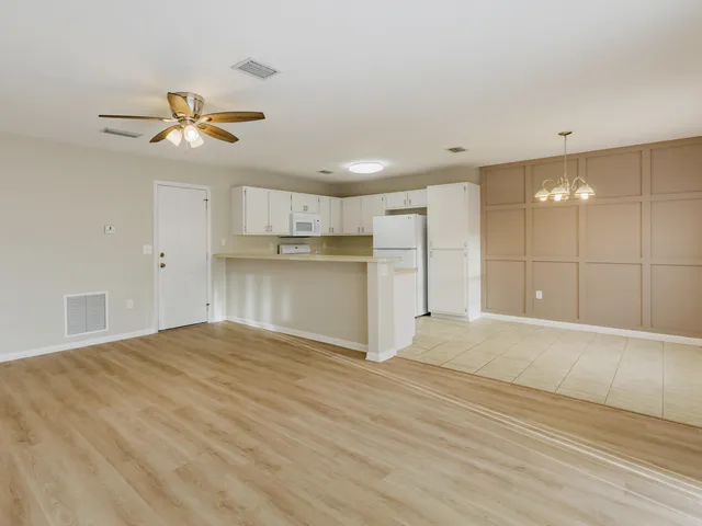 a view of a kitchen with a sink and a refrigerator