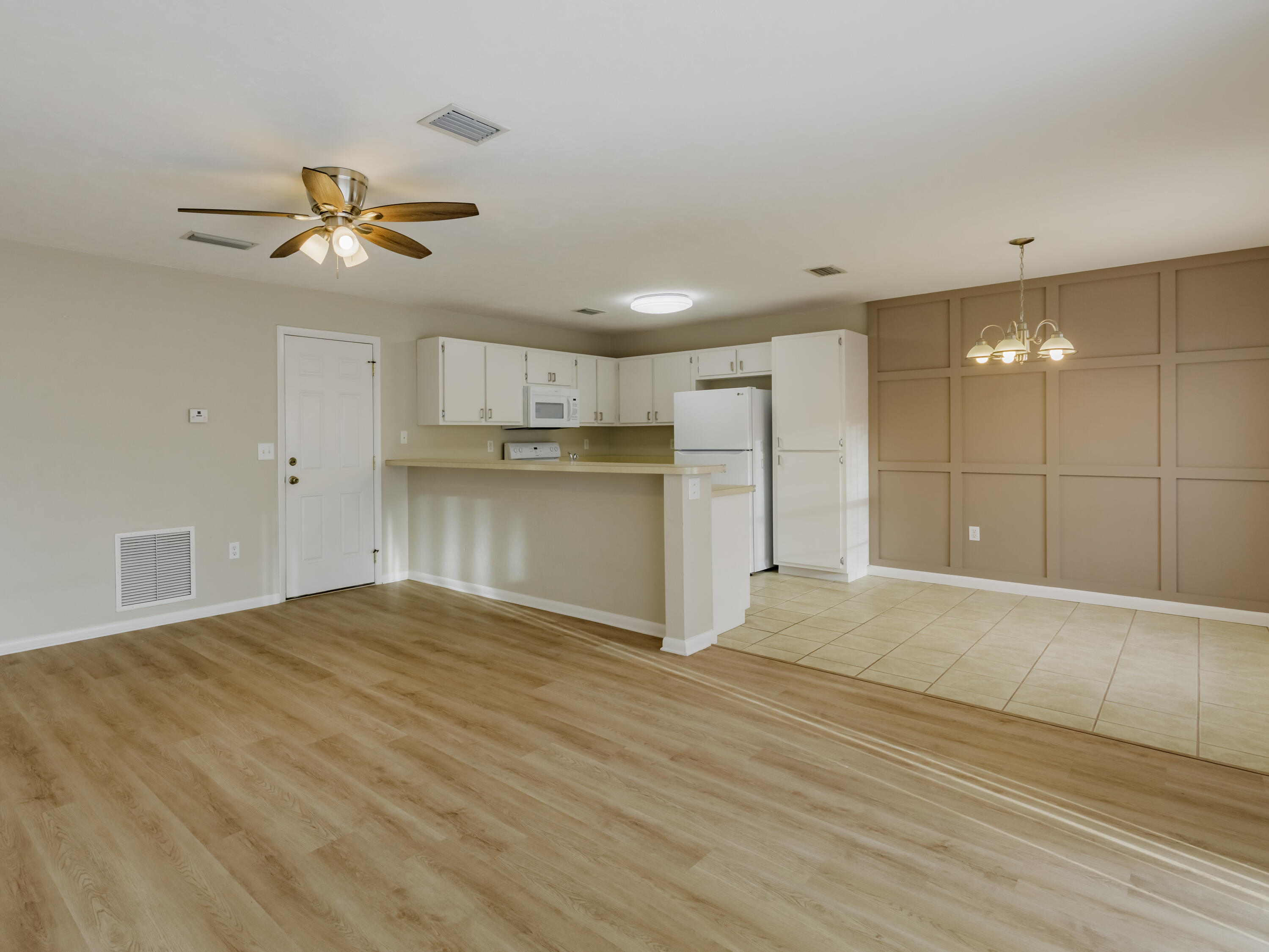 6367 Northwest 109th Place Alachua, FL 32615 - Photo 2 of 15 a view of a kitchen with a sink and a refrigerator