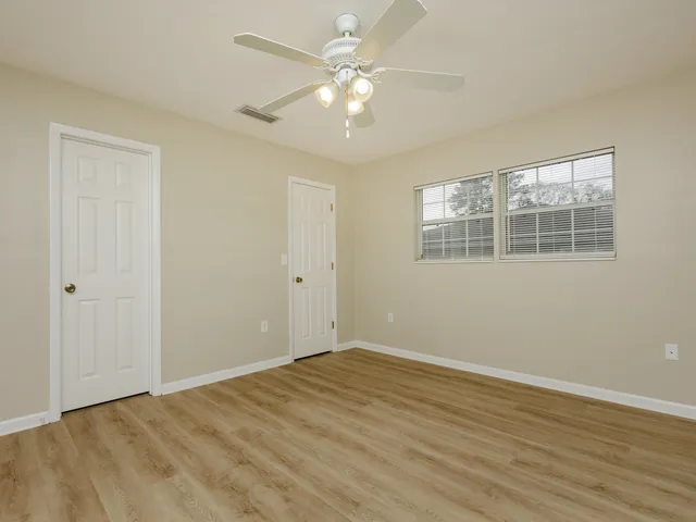 wooden floor in an empty room with a window