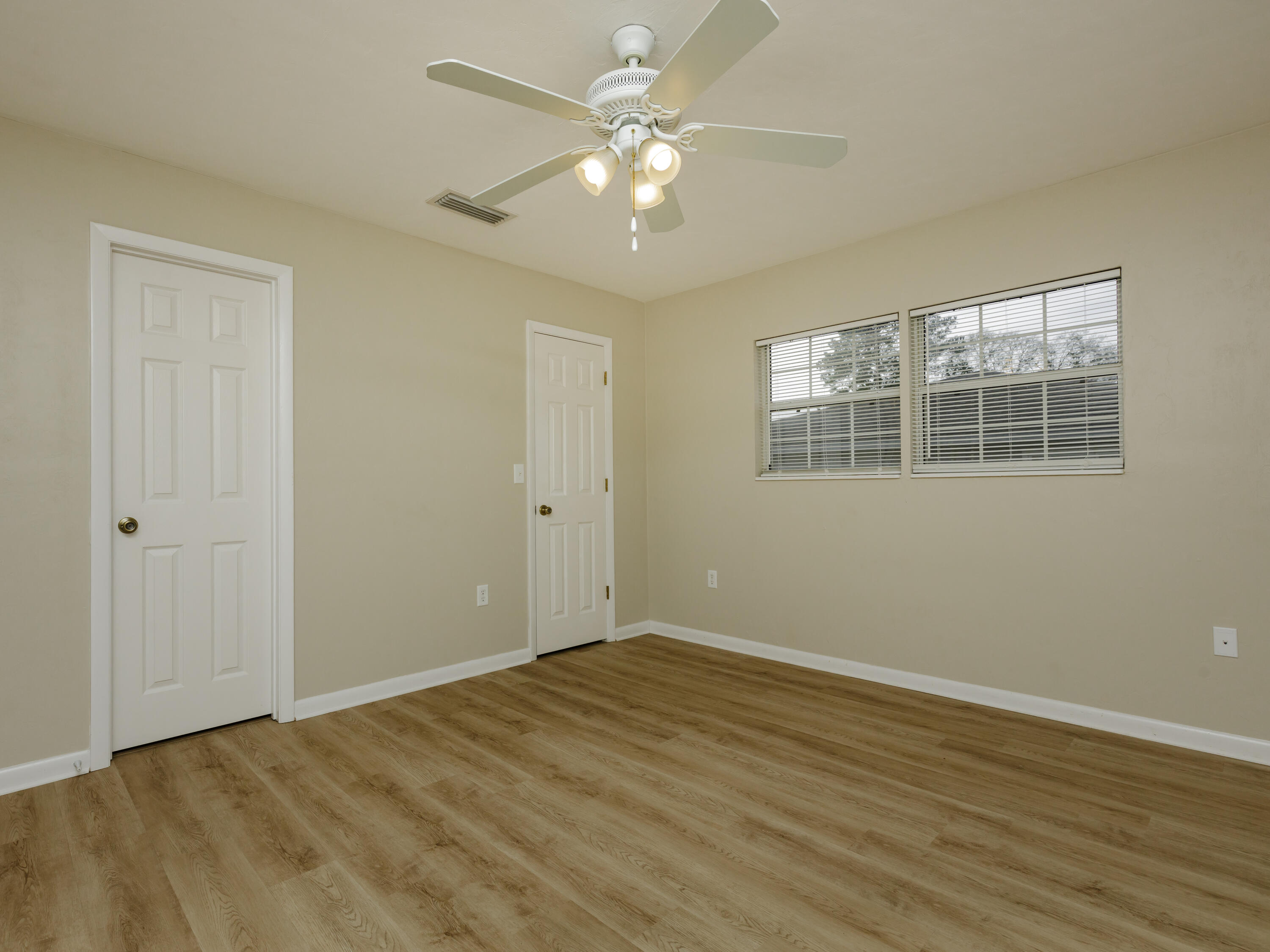 6367 Northwest 109th Place Alachua, FL 32615 - Photo 4 of 15 wooden floor in an empty room with a window