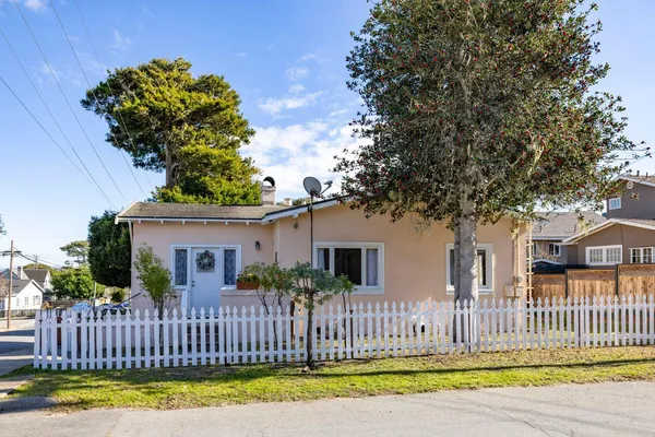 a front view of a house with a garden