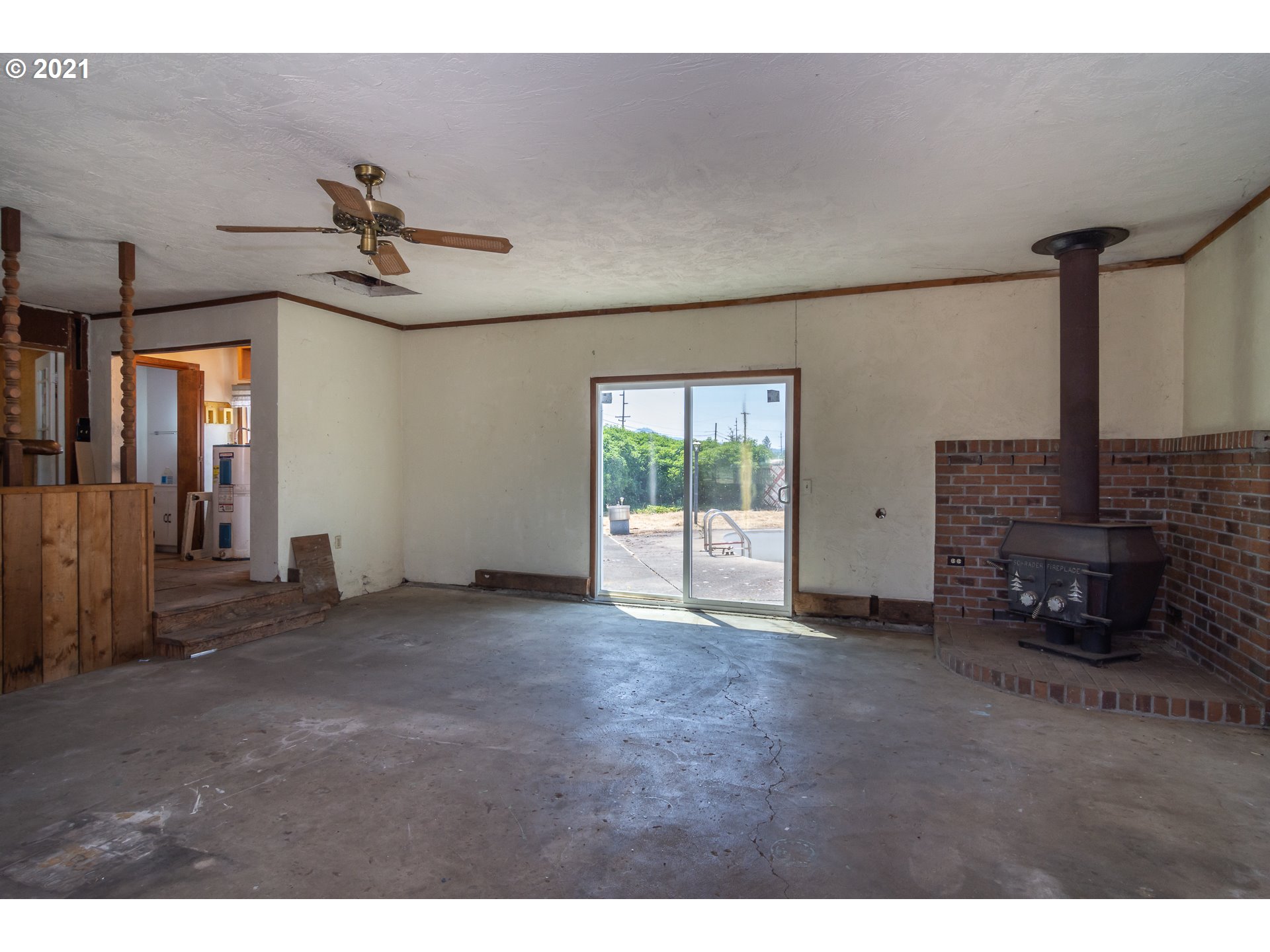 4200 Nonpareil Road Sutherlin, OR 97479 - Photo 12 of 32 a view of empty room with fireplace and fan