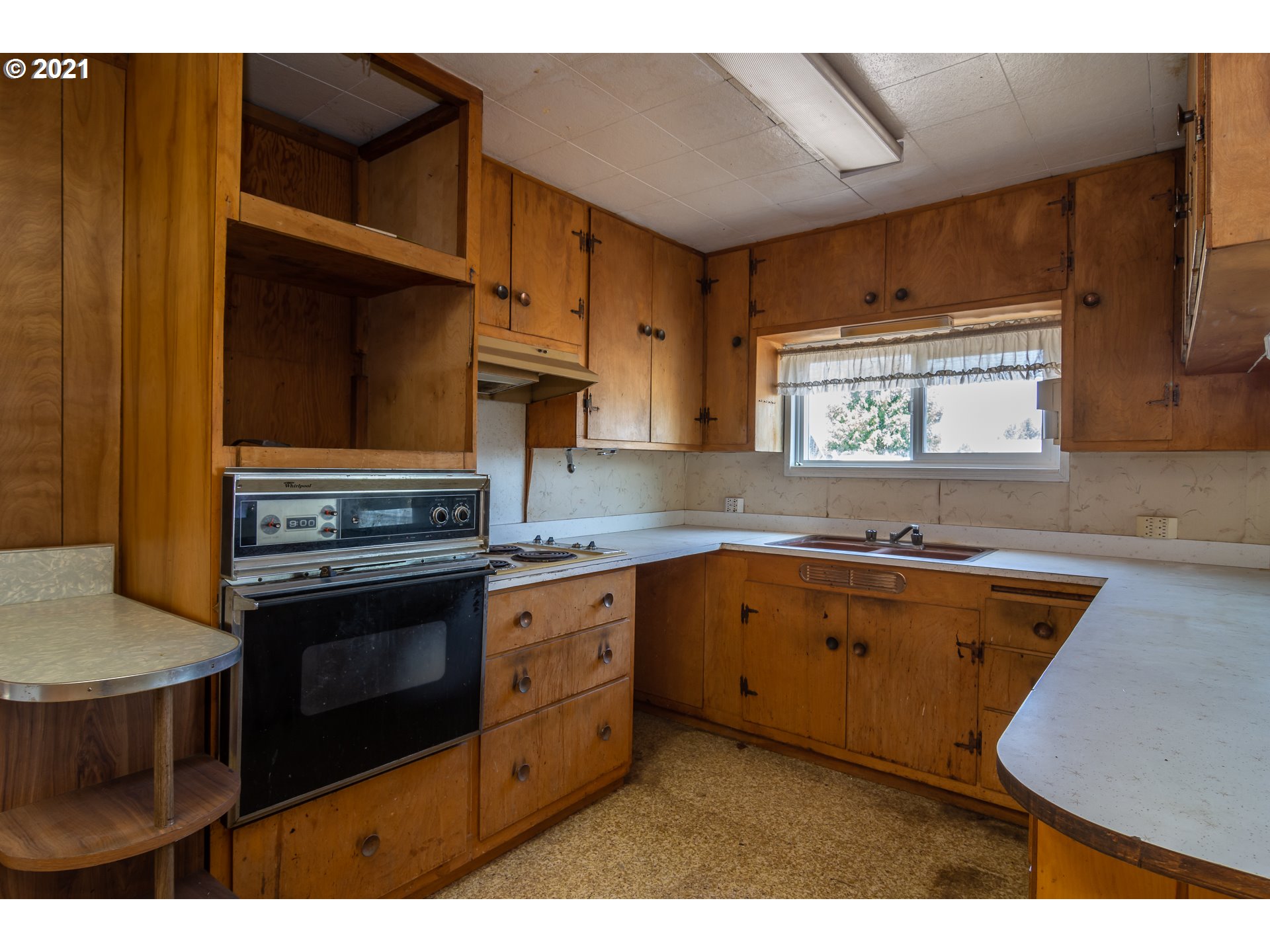 4200 Nonpareil Road Sutherlin, OR 97479 - Photo 8 of 32 a kitchen with wooden cabinets a sink and a stove