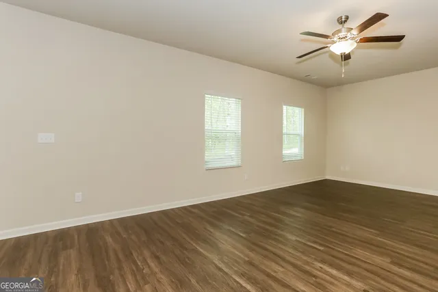 a kitchen with stainless steel appliances granite countertop a refrigerator a sink a stove a microwave and wooden cabinets