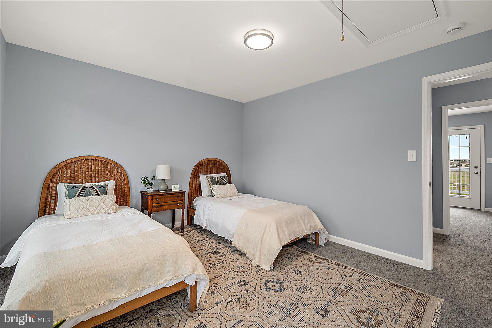 135 Jamestown Road, Unit 18A Ocean City, MD 21842 - Photo 34 of 63 a bedroom with two beds and wooden floor