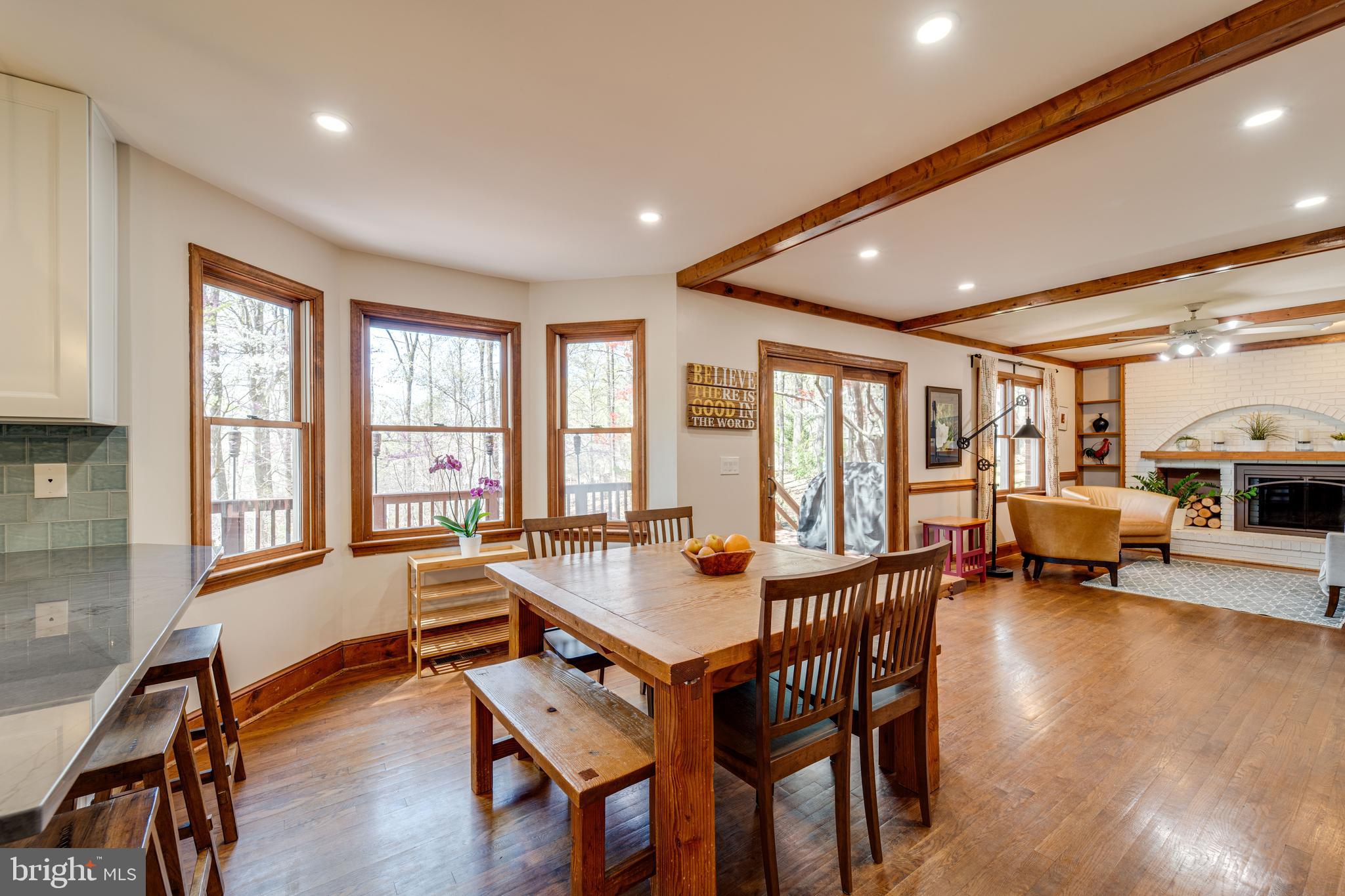8232 Honeysuckle Road Manassas, VA 20112 - Photo 18 of 76 a dining room with furniture a couch and wooden floor
