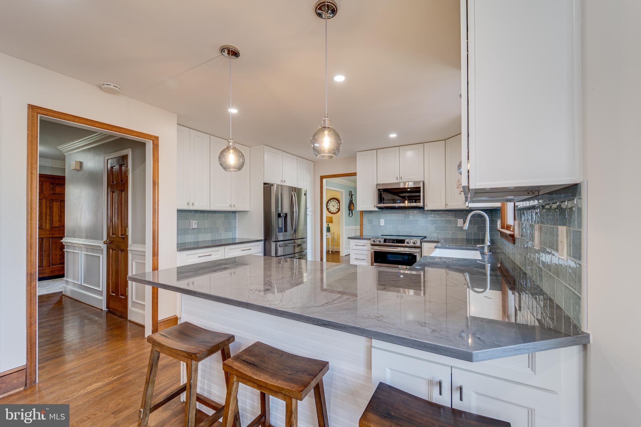 8232 Honeysuckle Road Manassas, VA 20112 - Photo 19 of 76 a kitchen with stainless steel appliances granite countertop a sink refrigerator and cabinets