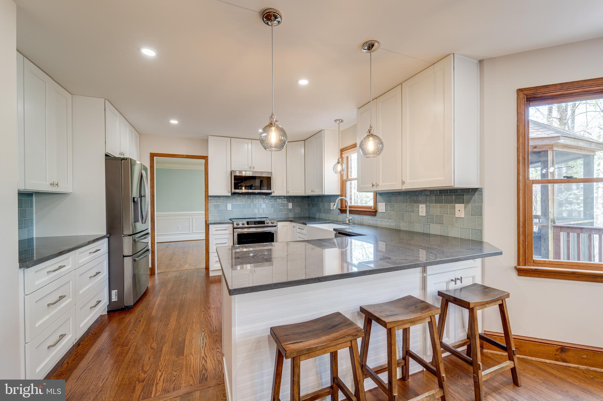 8232 Honeysuckle Road Manassas, VA 20112 - Photo 20 of 76 a kitchen with granite countertop white cabinets and stainless steel appliances
