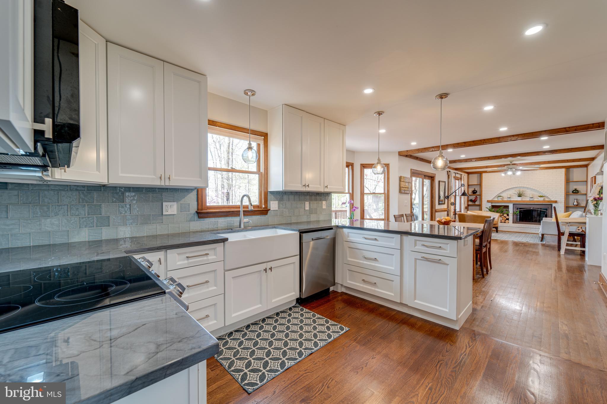8232 Honeysuckle Road Manassas, VA 20112 - Photo 25 of 76 a kitchen with stainless steel appliances granite countertop a stove a sink and a microwave