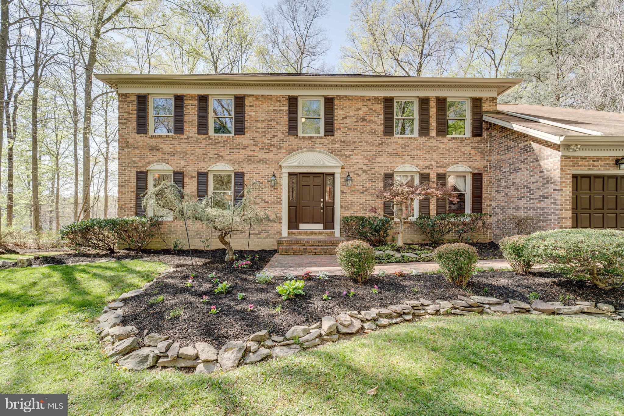 8232 Honeysuckle Road Manassas, VA 20112 - Photo 3 of 76 a front view of a house with garden
