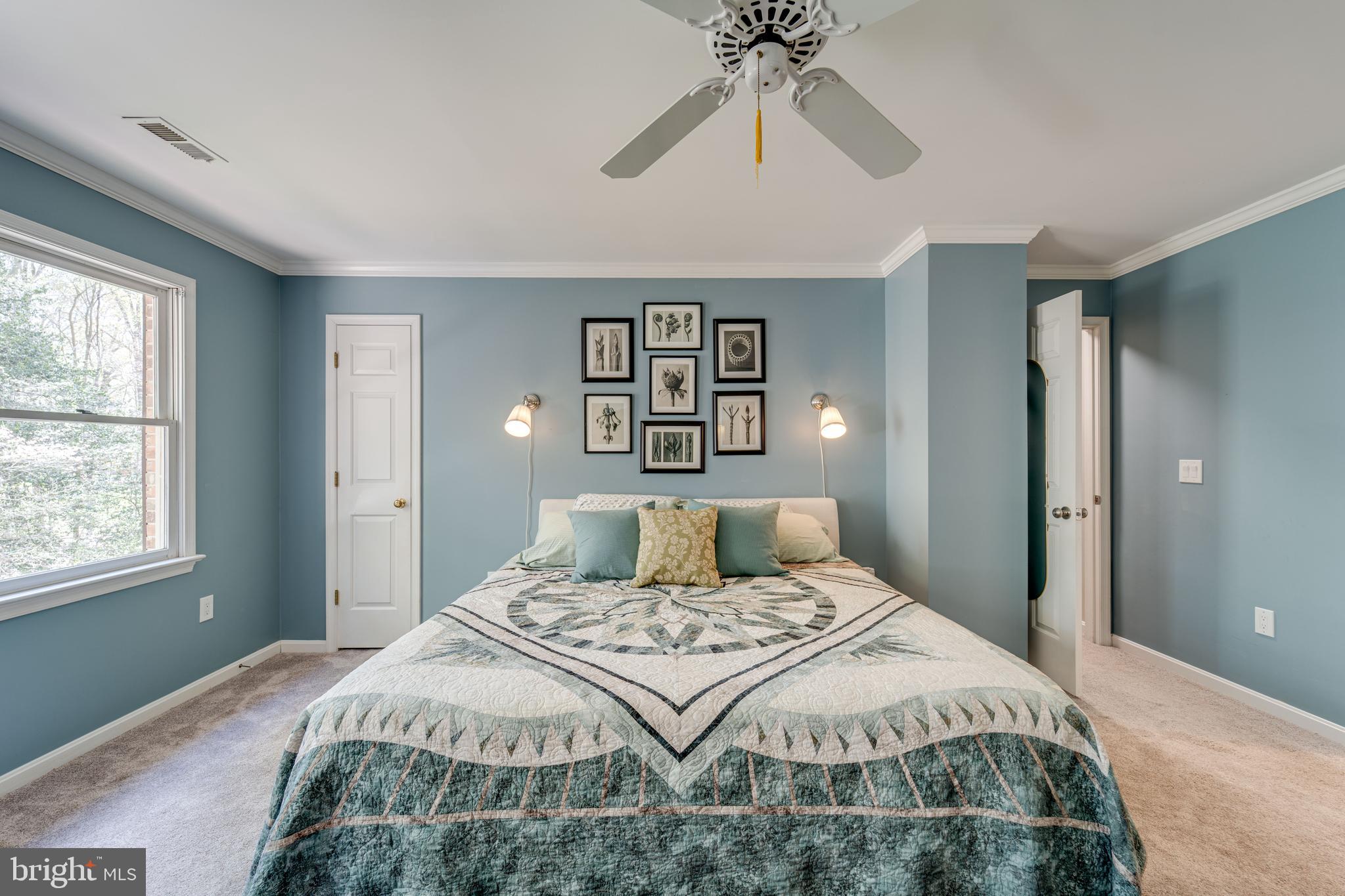 8232 Honeysuckle Road Manassas, VA 20112 - Photo 32 of 76 a bedroom with a large bed and a chandelier