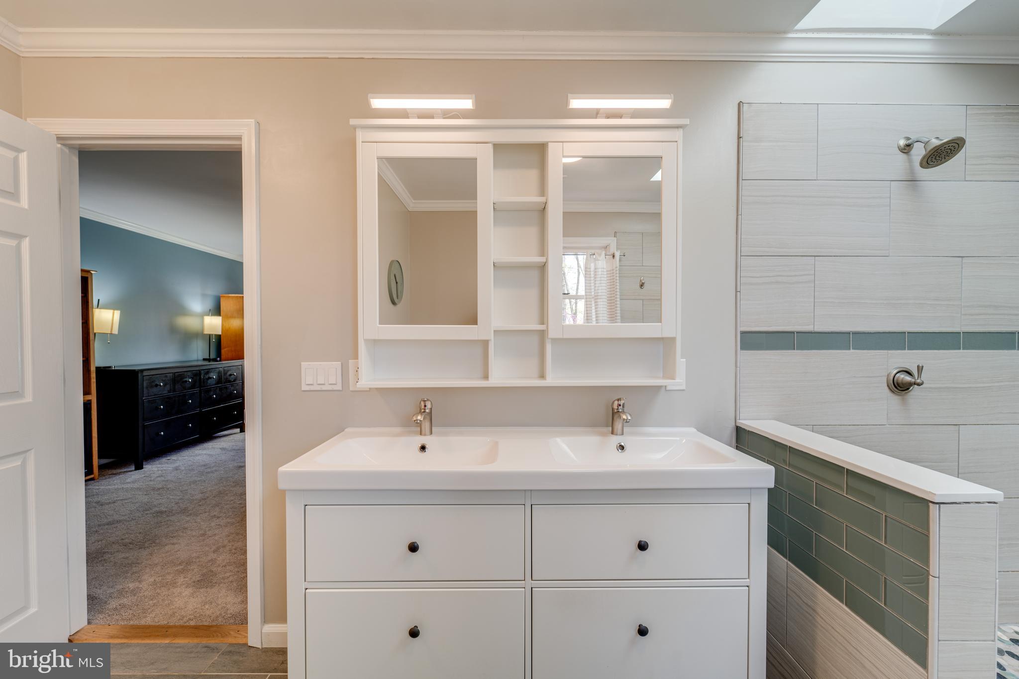8232 Honeysuckle Road Manassas, VA 20112 - Photo 36 of 76 a bathroom with a sink double vanity and a shower