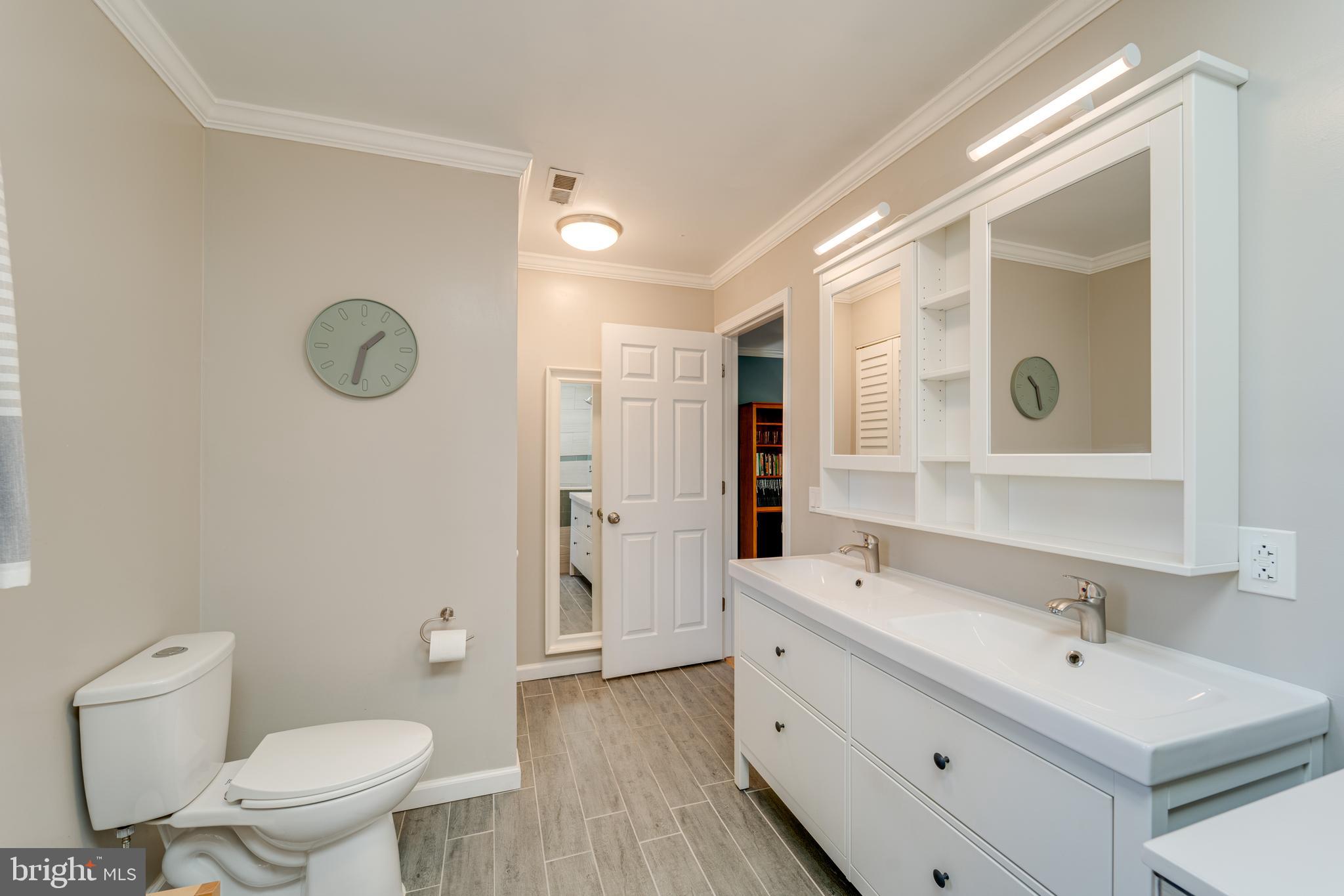 8232 Honeysuckle Road Manassas, VA 20112 - Photo 37 of 76 a bathroom with a double vanity sink mirror and toilet