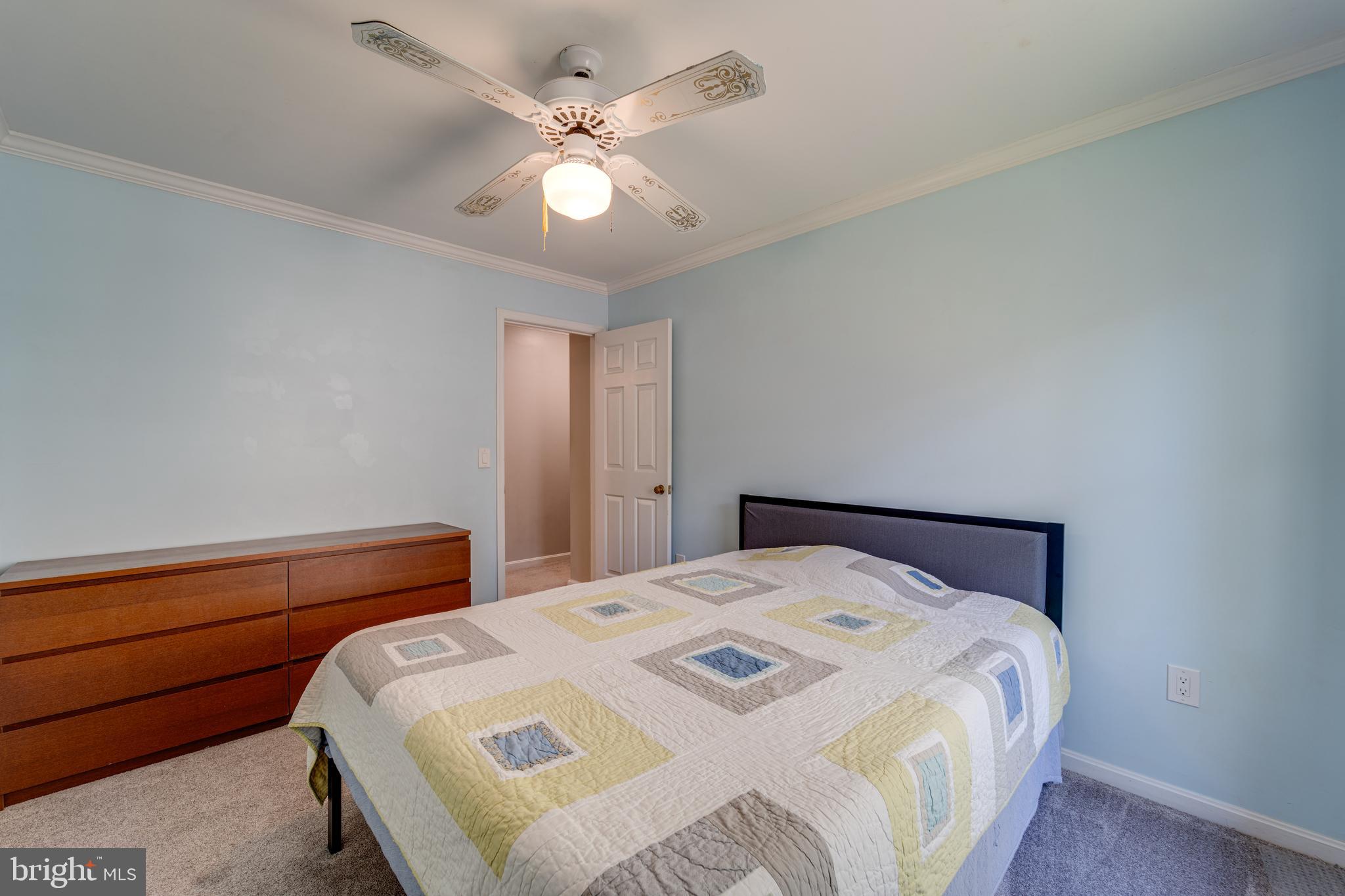 8232 Honeysuckle Road Manassas, VA 20112 - Photo 39 of 76 a bedroom with a bed and a chandelier