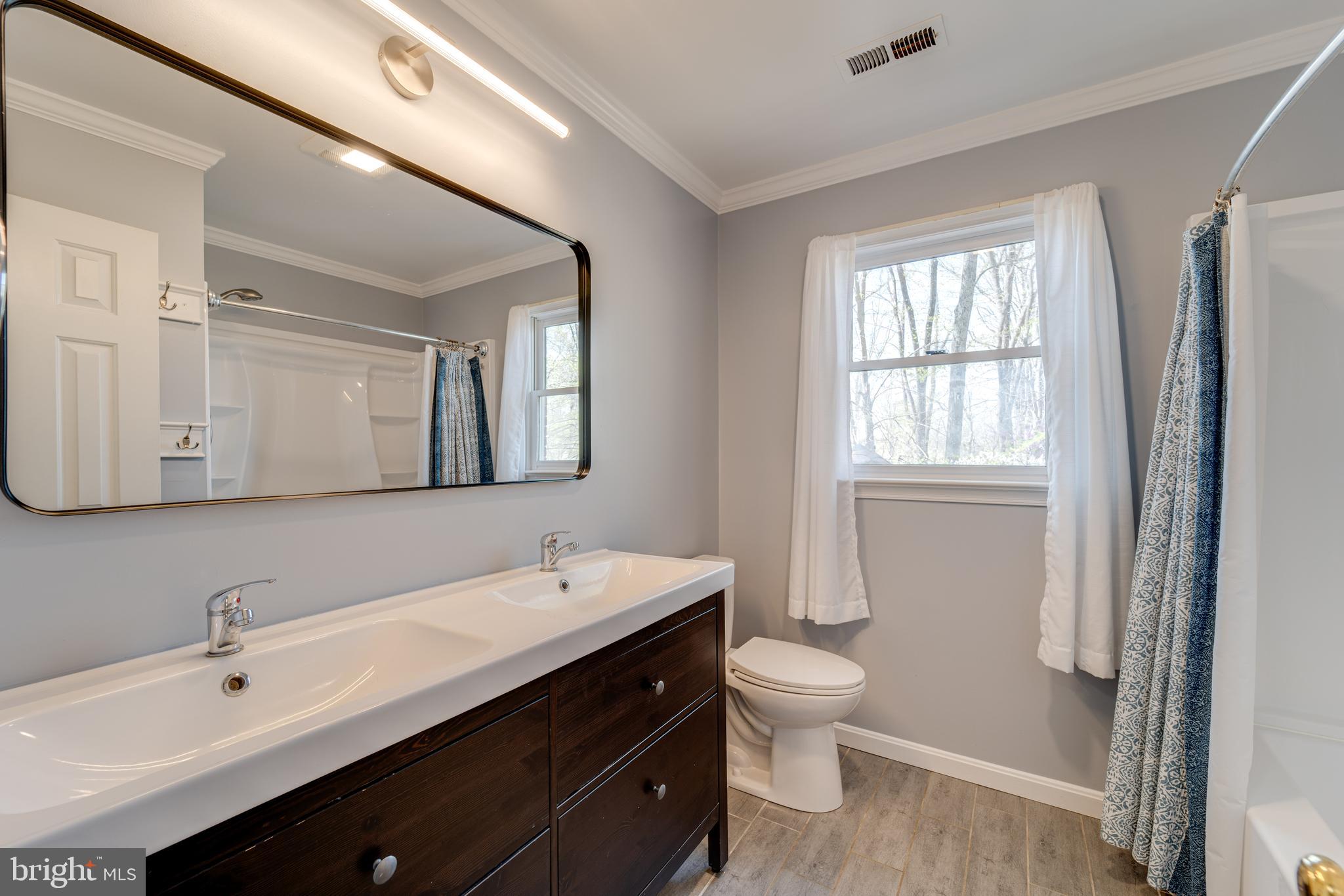 8232 Honeysuckle Road Manassas, VA 20112 - Photo 45 of 76 a bathroom with a double vanity sink mirror and toilet