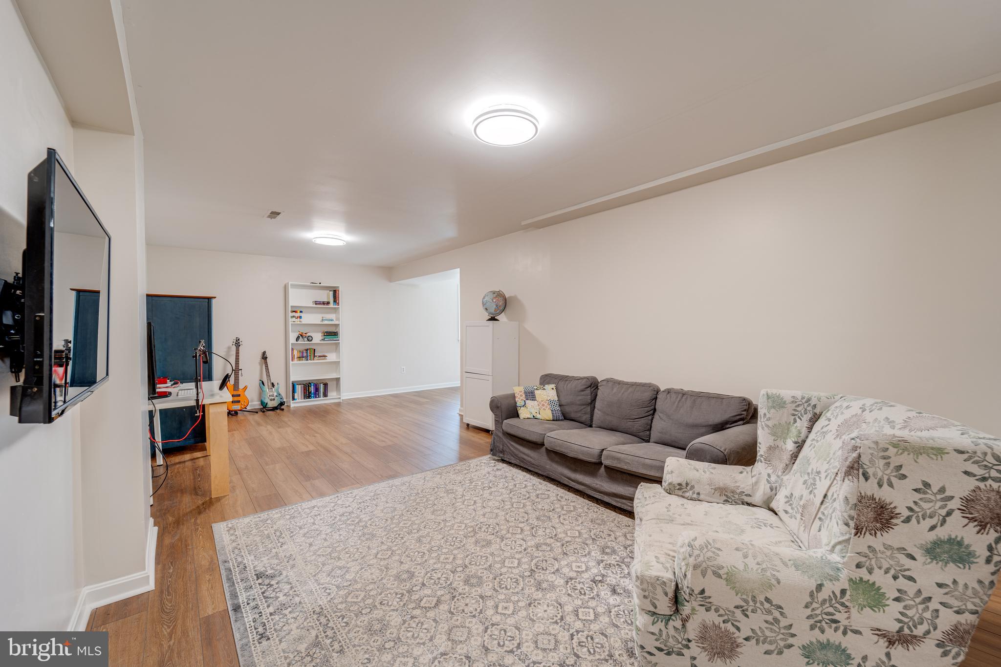 8232 Honeysuckle Road Manassas, VA 20112 - Photo 48 of 76 a living room with furniture and a flat screen tv