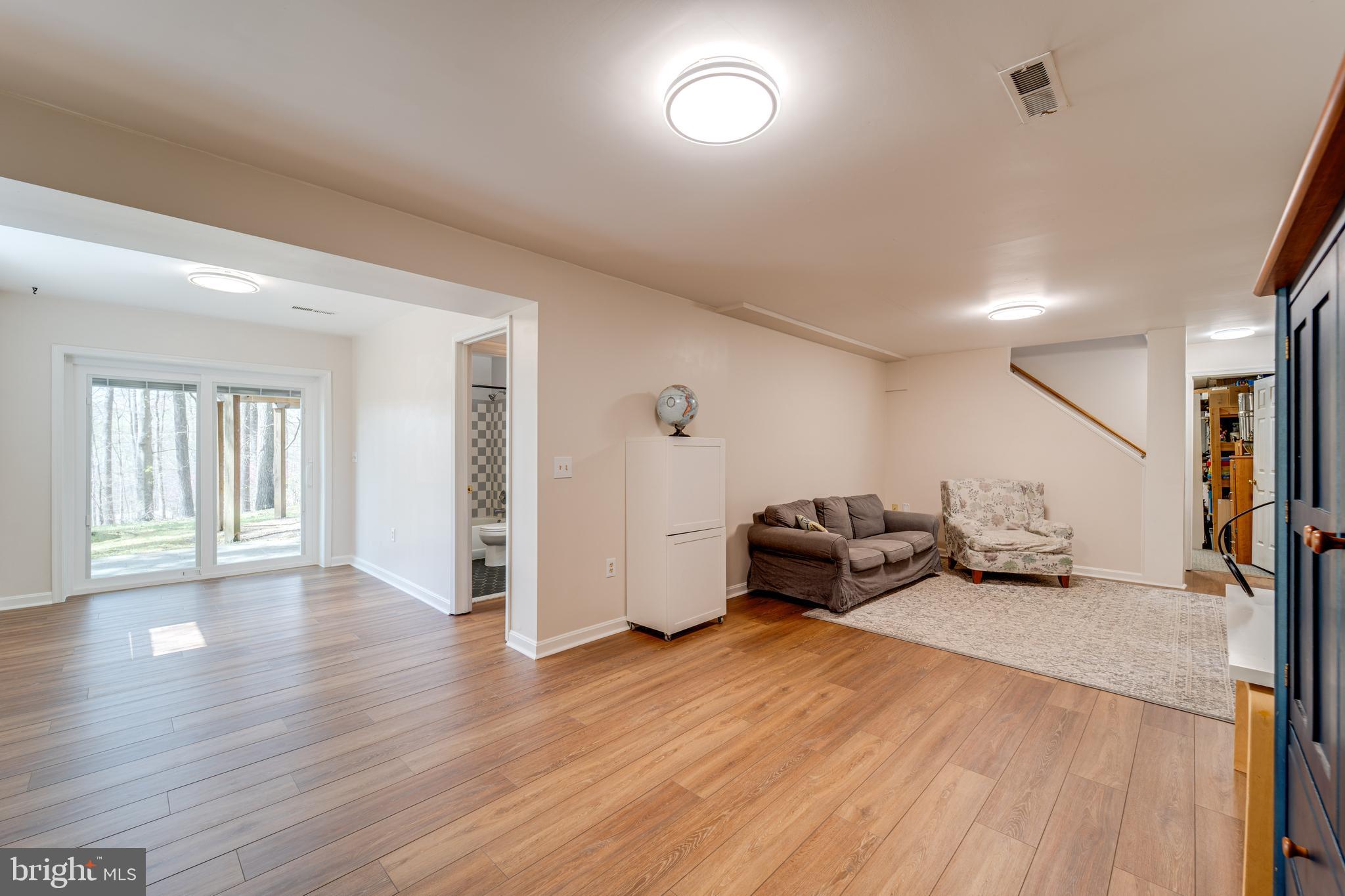 8232 Honeysuckle Road Manassas, VA 20112 - Photo 50 of 76 a living room with furniture and a wooden floor