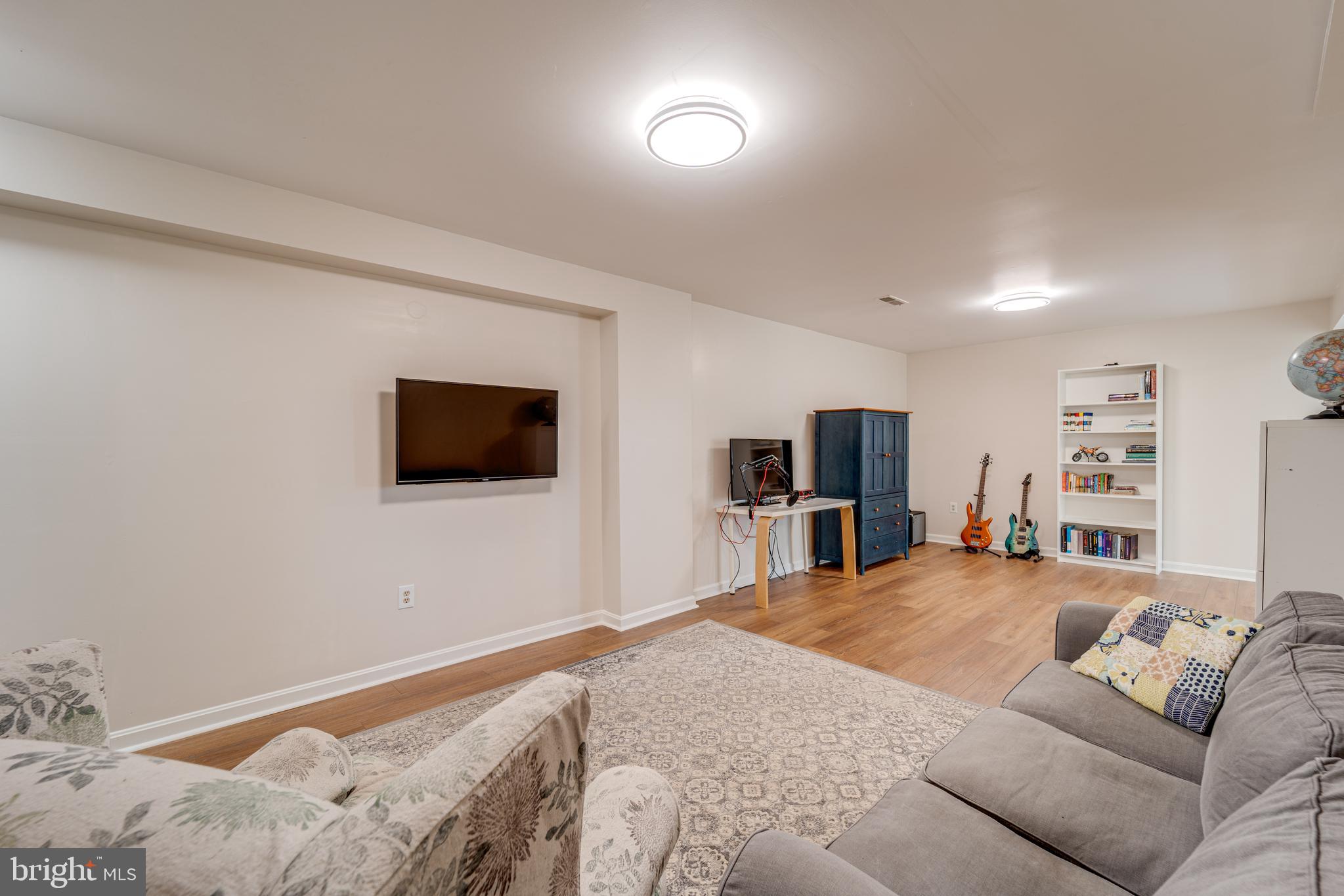 8232 Honeysuckle Road Manassas, VA 20112 - Photo 52 of 76 a living room with furniture and a flat screen tv