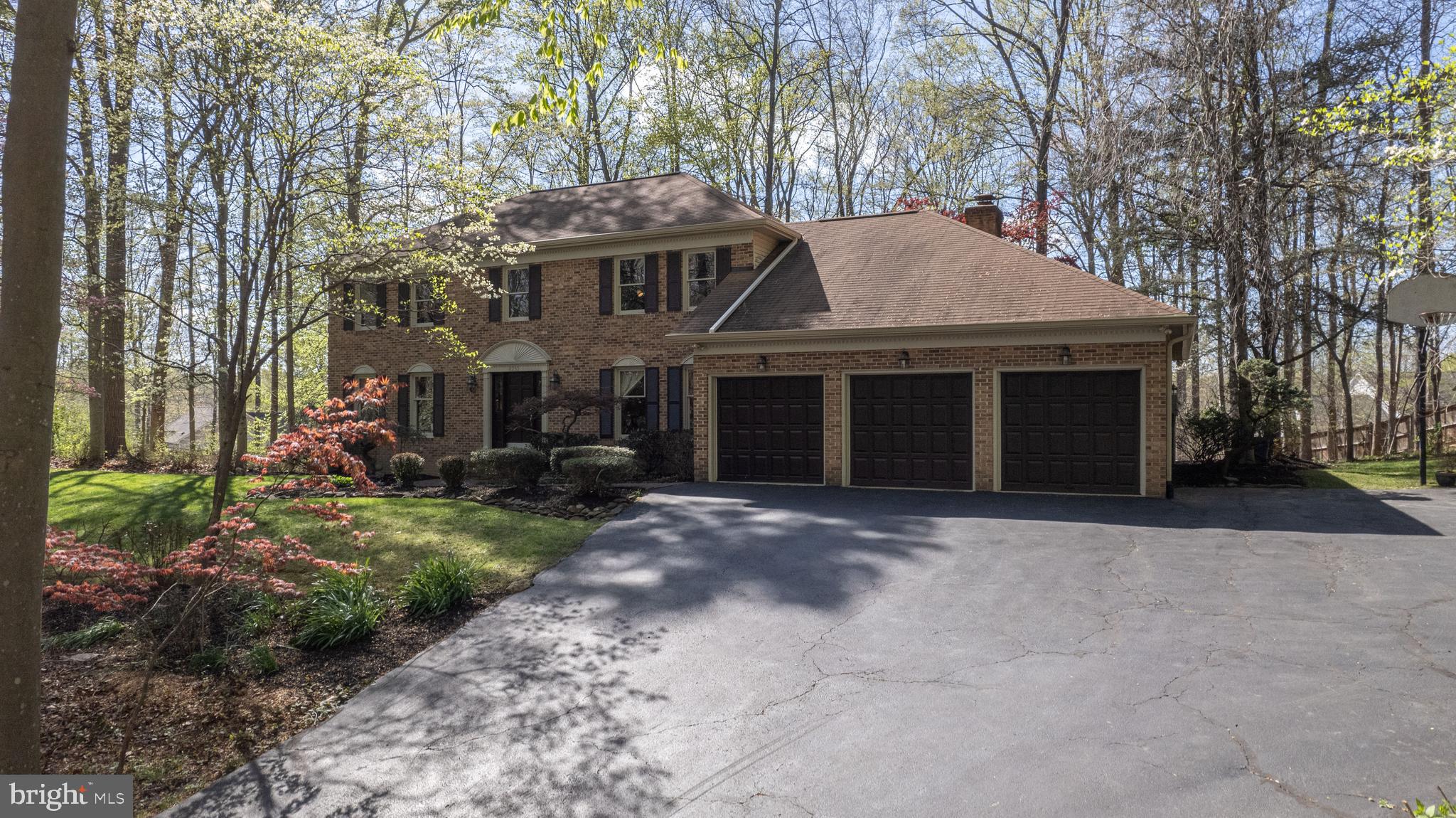 8232 Honeysuckle Road Manassas, VA 20112 - Photo 76 of 76 a front view of a house with a garden and trees