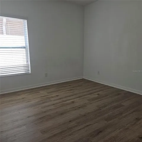 a spacious bathroom with a granite countertop sink a mirror and a shower
