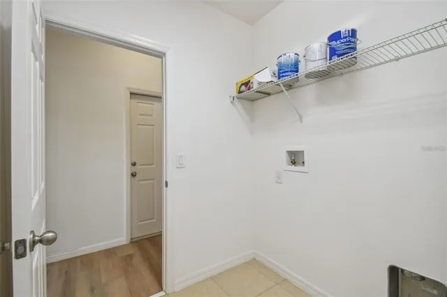 a view of storage and utility room with racks on the wall