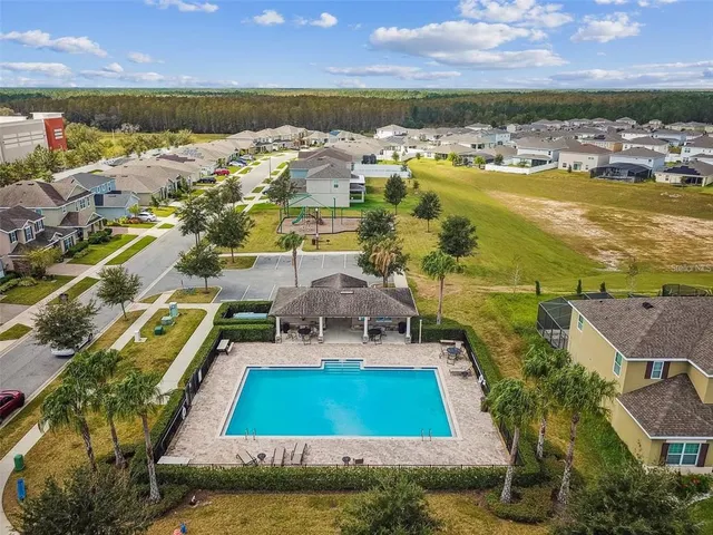 a swimming pool with outdoor seating and yard