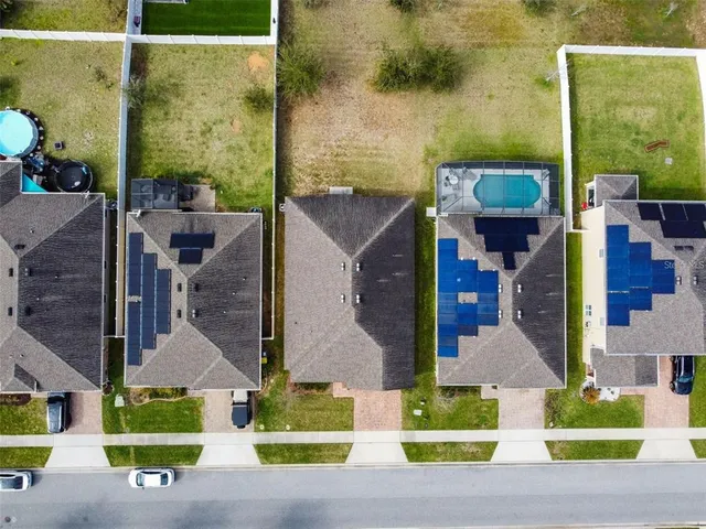 an aerial view of houses with a yard