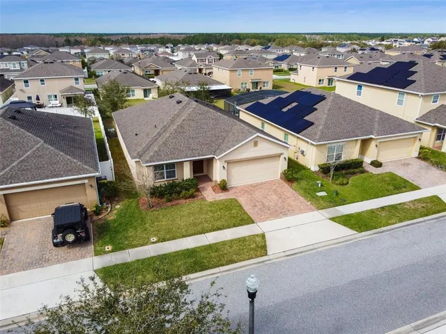 a view of multiple houses with yard