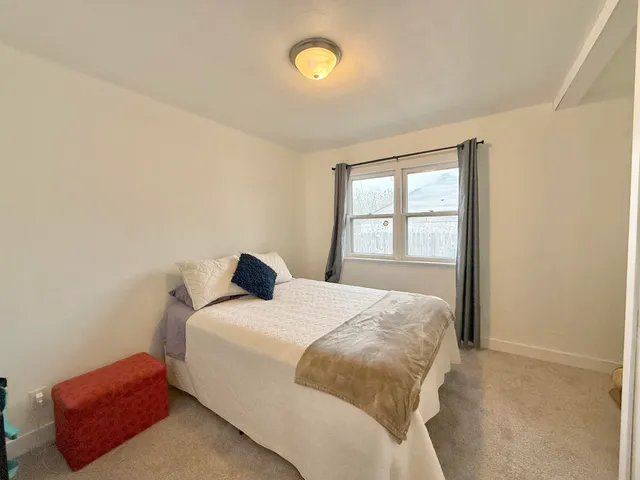 a bedroom with a bed and window