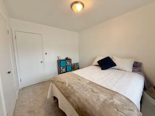 a bedroom with a bed and a lamp
