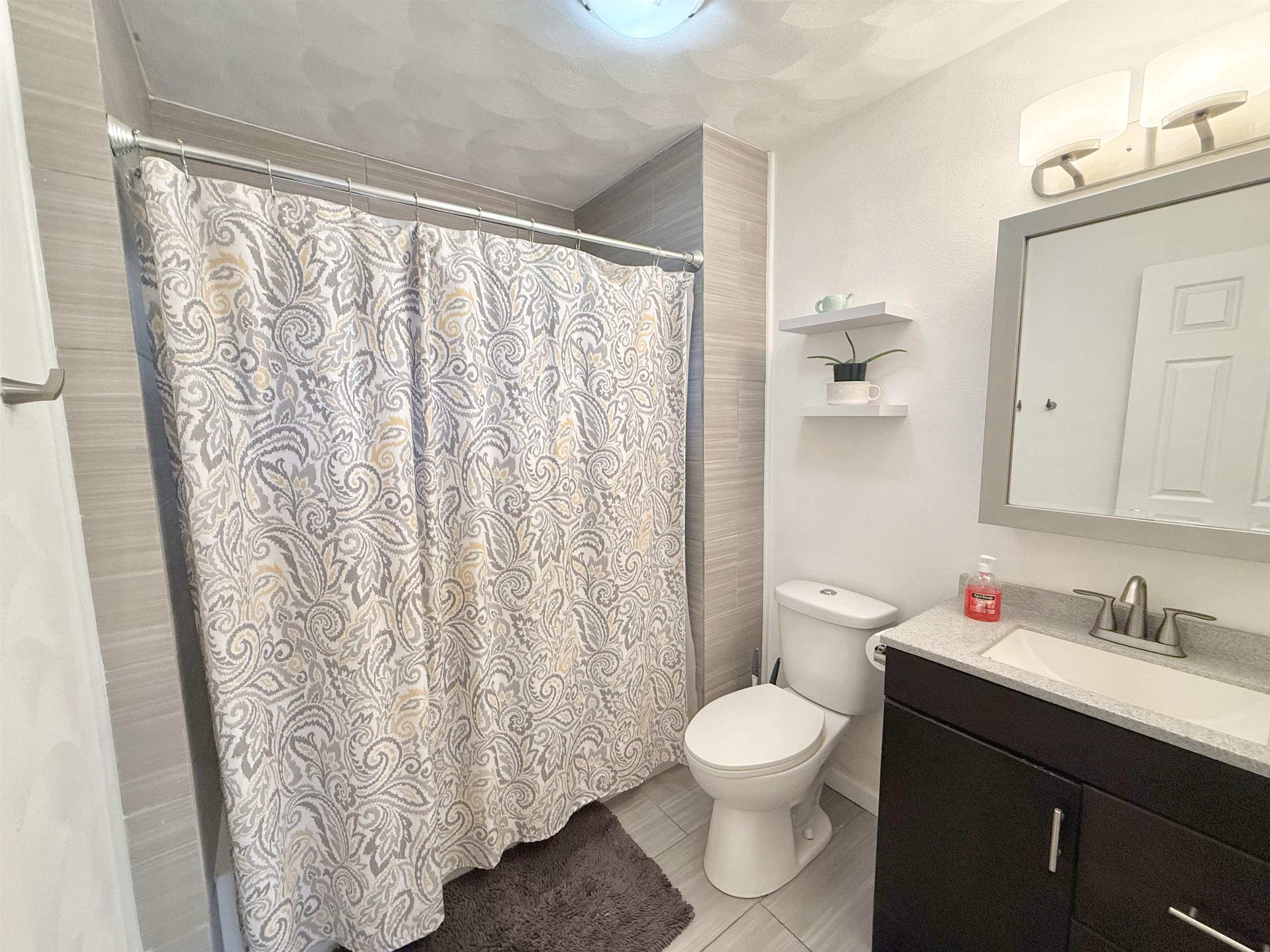 8432 Ravere Street Machesney Park, IL 61115 - Photo 14 of 31 a bathroom with a granite countertop sink and a toilet