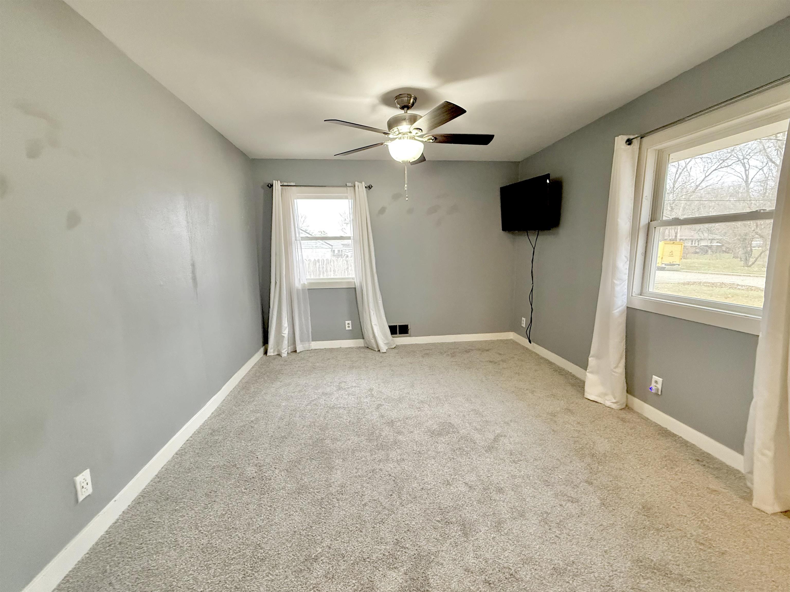8432 Ravere Street Machesney Park, IL 61115 - Photo 15 of 31 a view of a livingroom with a ceiling fan and window