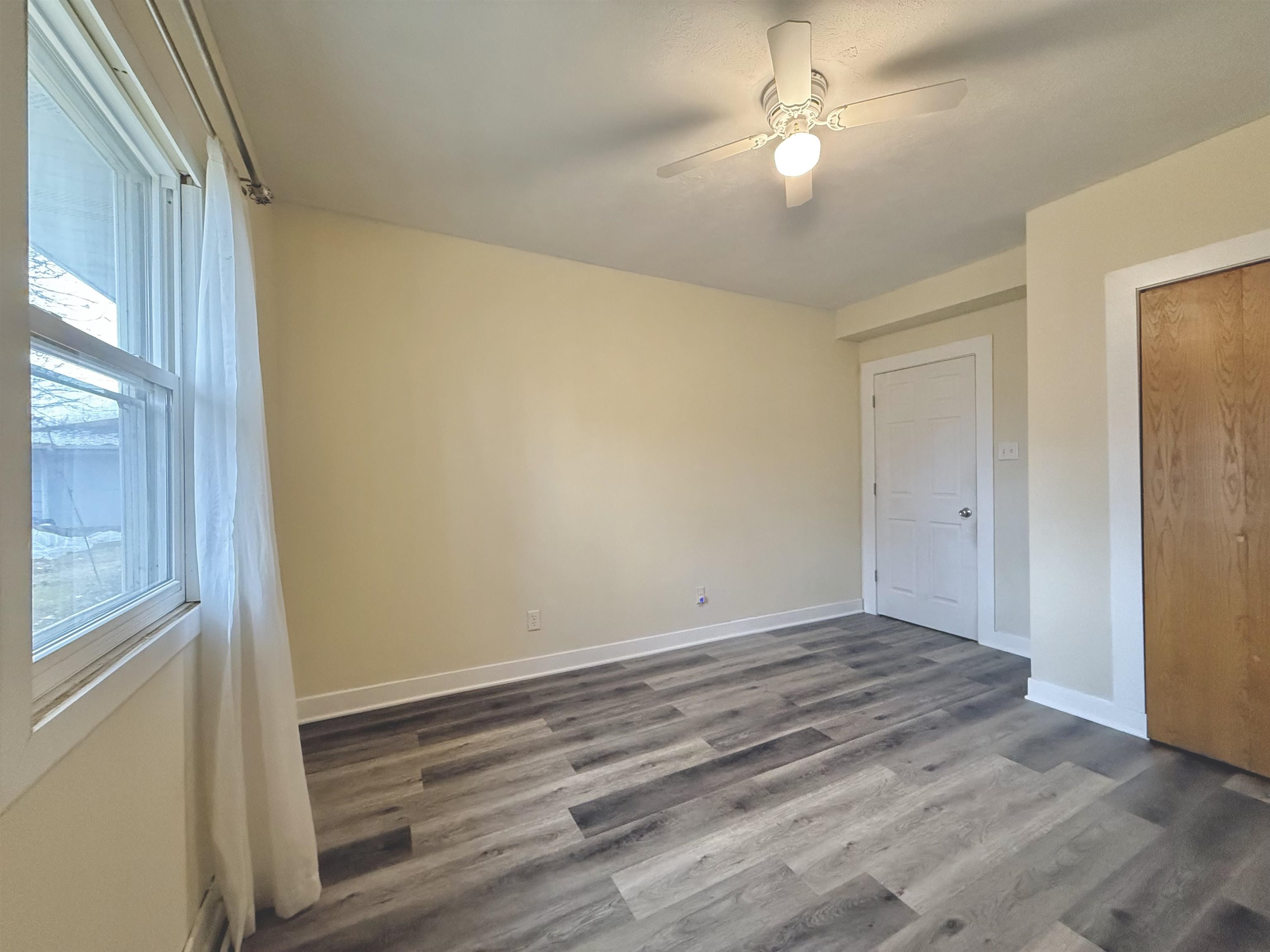 8432 Ravere Street Machesney Park, IL 61115 - Photo 20 of 31 a view of room with window and hardwood floor