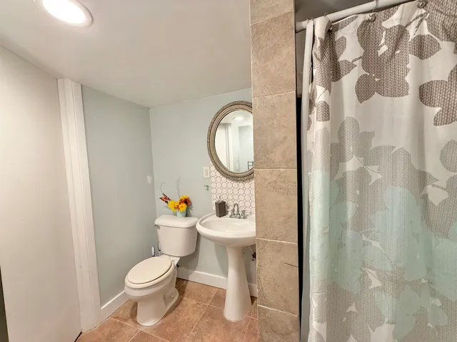 a white toilet sitting next to a bathroom sink