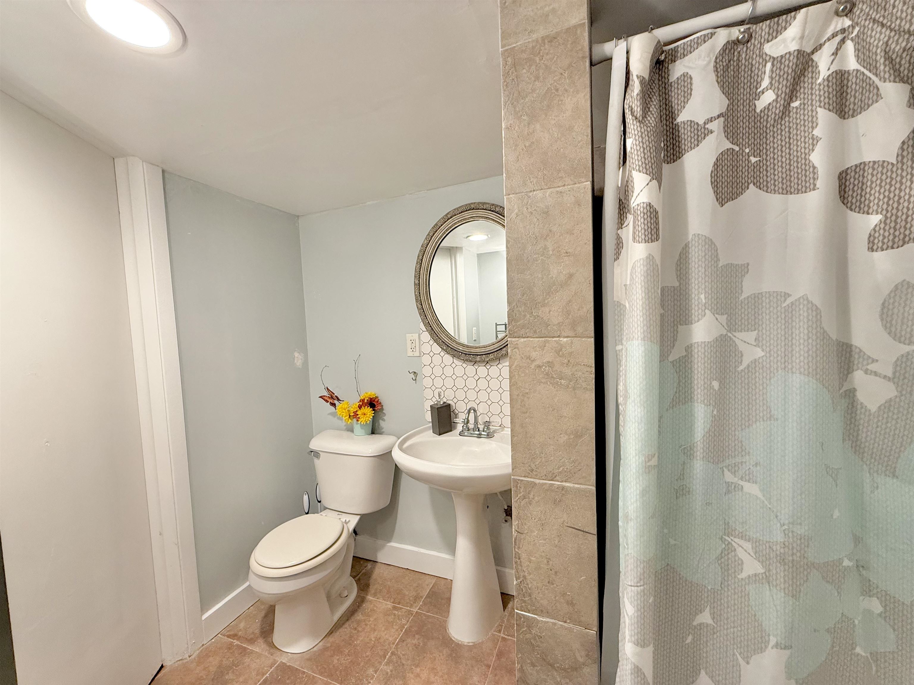 8432 Ravere Street Machesney Park, IL 61115 - Photo 26 of 31 a white toilet sitting next to a bathroom sink